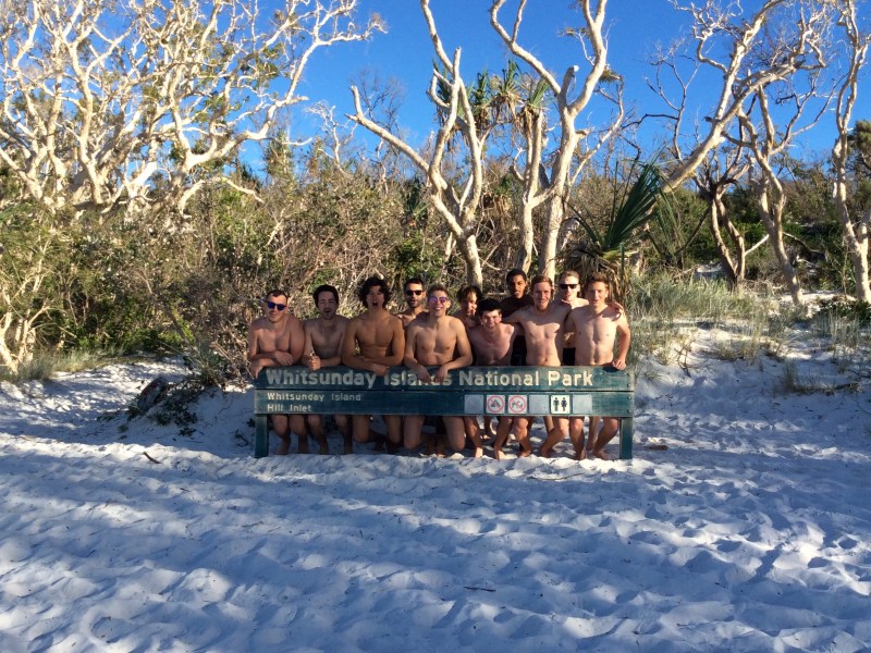 a group of people riding skis across snow covered ground