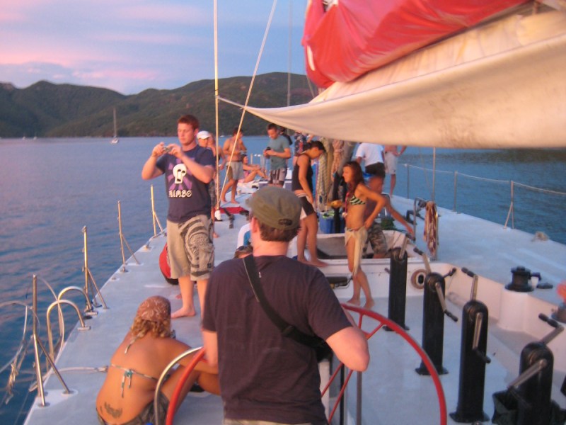 a group of people standing next to a body of water