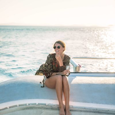 a person sitting next to a body of water