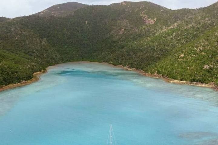 a body of water with a mountain in the background
