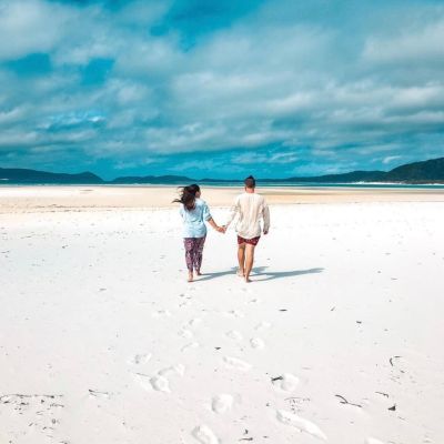 a man standing on top of a sandy beach