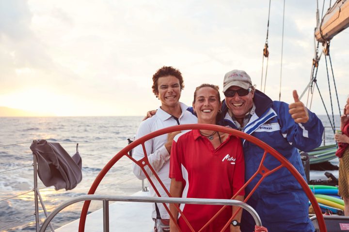 a man and a woman standing next to a body of water