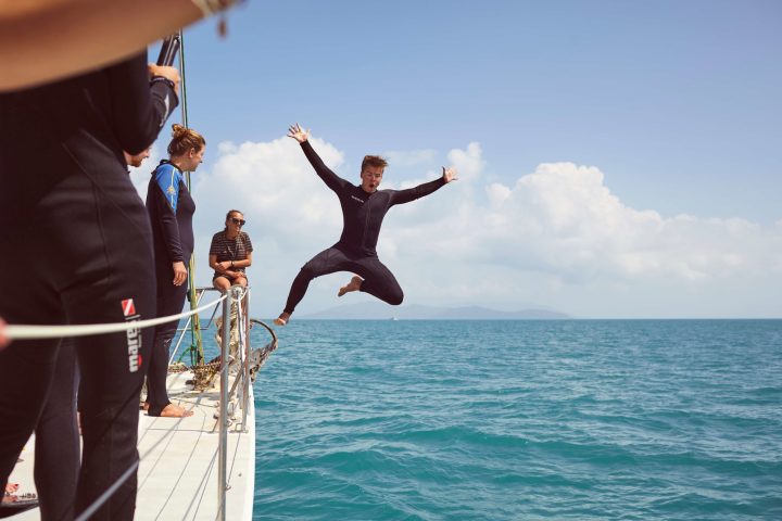 a couple of people that are standing in the water