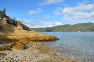 a rocky shore next to a body of water